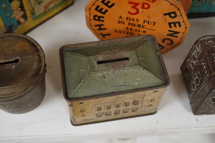 A quantity of various painted tin money boxes including Lucie Attwell Fairy House, The ‘Daily Mail’ copper bank, and four in the form of books, largest 20cm high. Condition - mostly fair